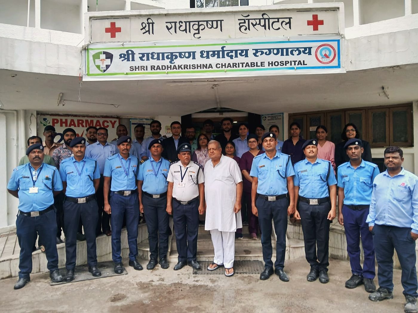 Hospital staff. Clinical and support staff outside the main entrance.